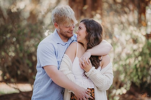 Couple wrapped in a hug on a warm autumn day