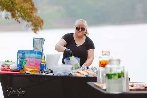 Volunteer preparing food at an outdoor event
