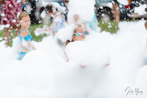 Girl covered in foam at a party