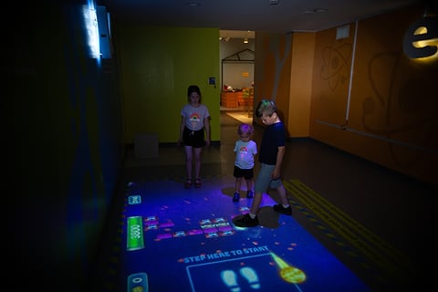 Kids playing an interactive floor projection game