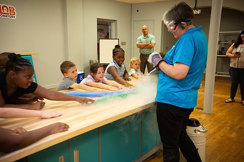 Science demonstration with dry-ice fog at a kids' museum