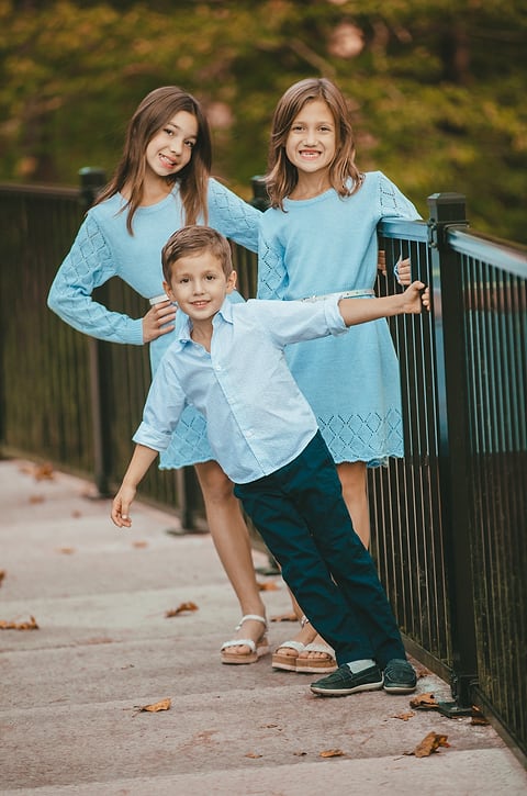 Siblings playing by a railing