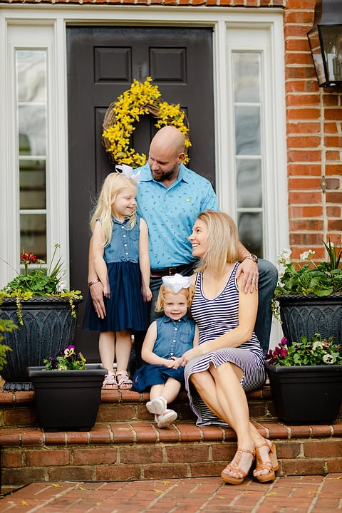Family portrait on the front steps of their home