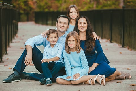 Family portrait on a park boardwalk in the fall