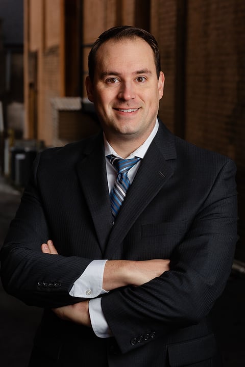 Executive headshot with arms crossed