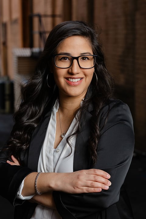 Professional woman in glasses with arms crossed