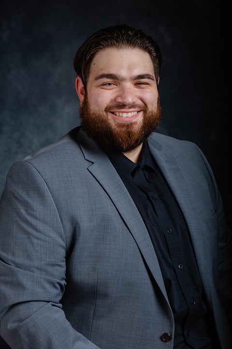 Studio business portrait of a bearded man in a gray blazer