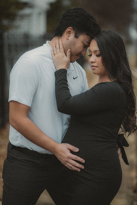 Expecting couple in a tender embrace