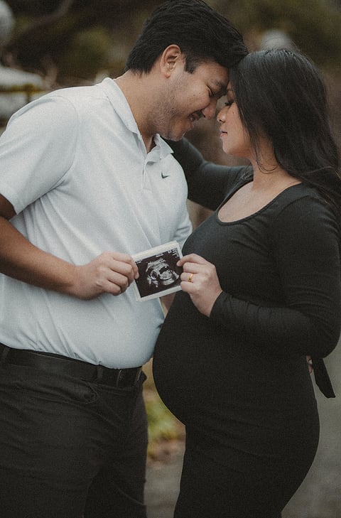 Expecting couple holding an ultrasound photo