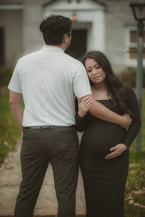 Mom-to-be leaning on her partner