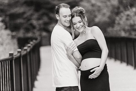 Black and white maternity portrait on a bridge