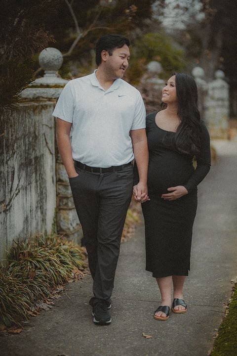 Expecting couple walking hand in hand