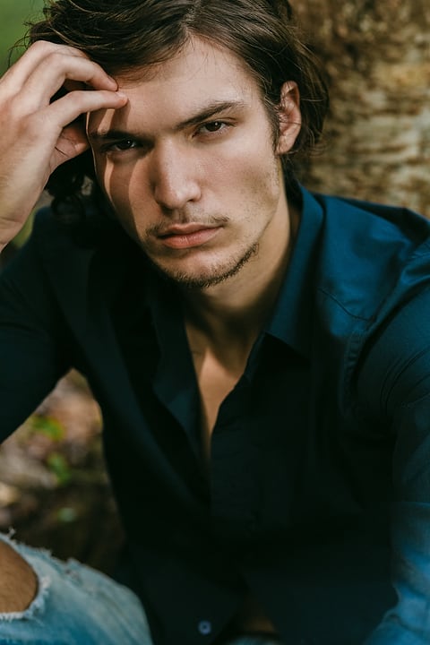 Male model in dark clothing, outdoor portrait
