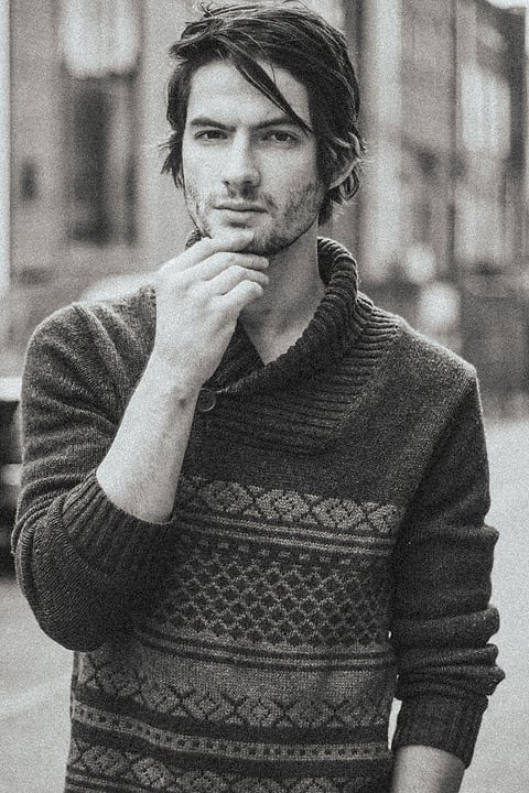 Black and white portrait of a male model in a knit sweater