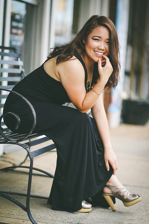 Model seated on a bench downtown