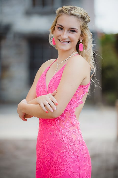 Prom portrait of a girl in a pink lace dress