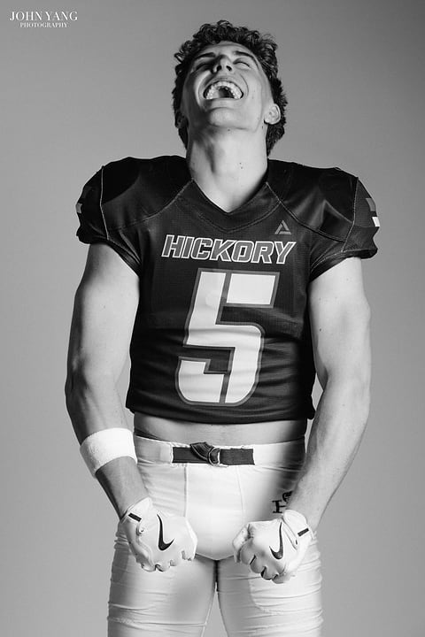 Black and white football player celebrating